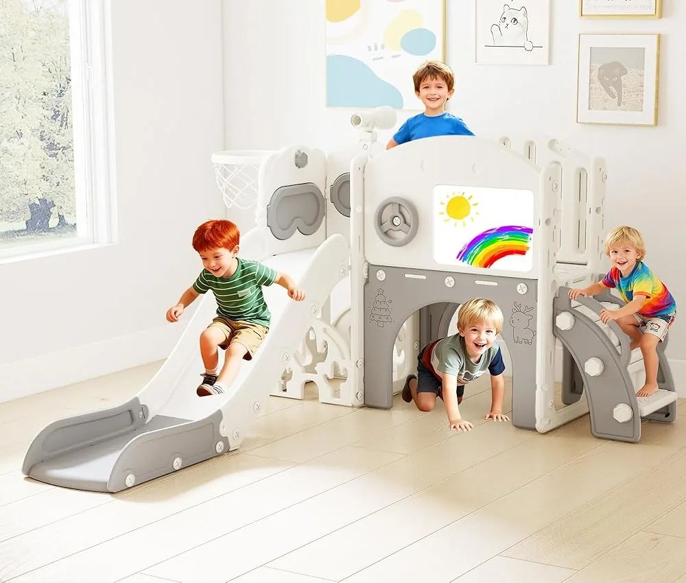 Children playing on a white indoor slide and climbing set